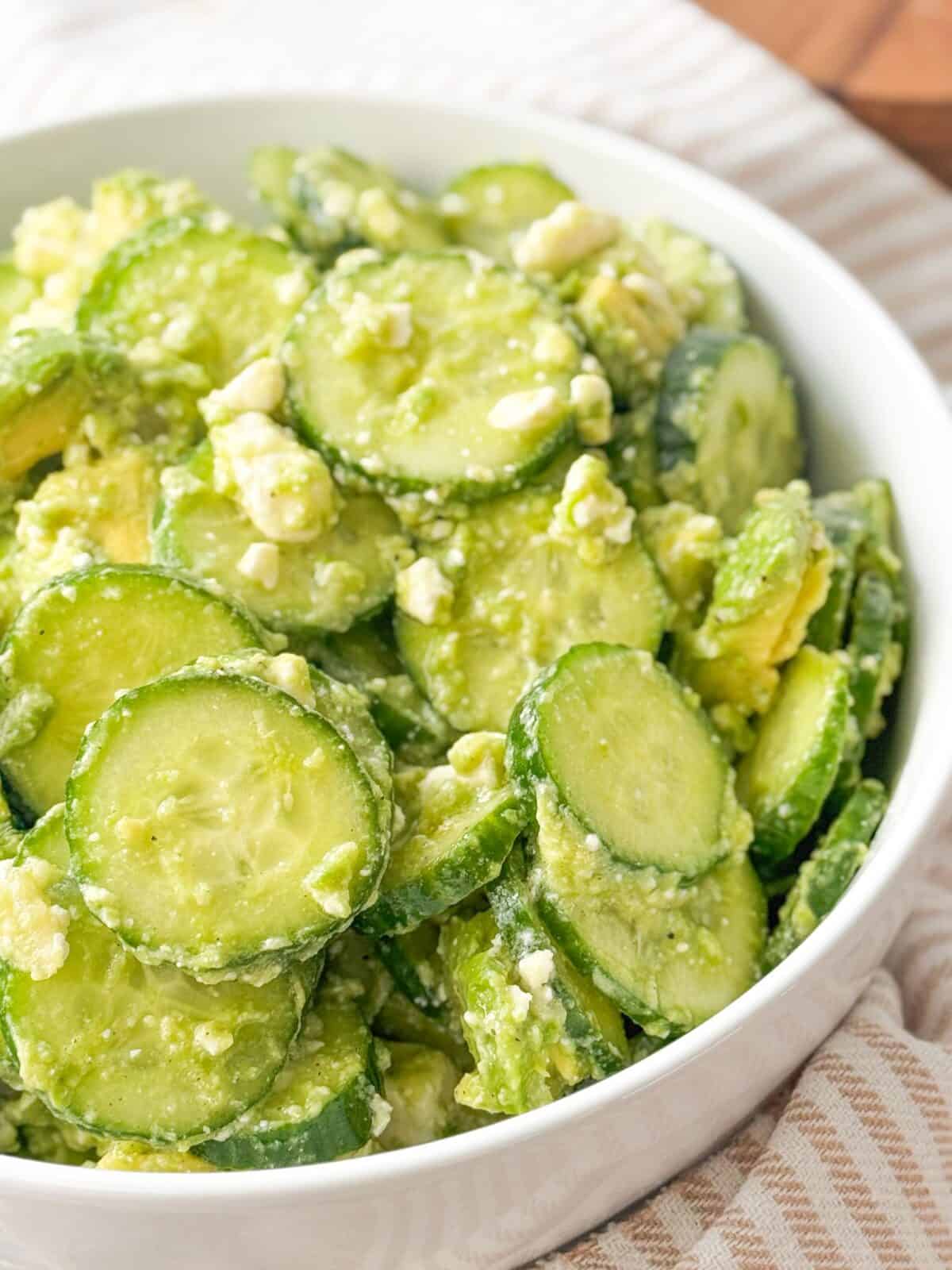 Feta Cucumber Salad close up shot of cucumber salad with feta cheese served in white bowl