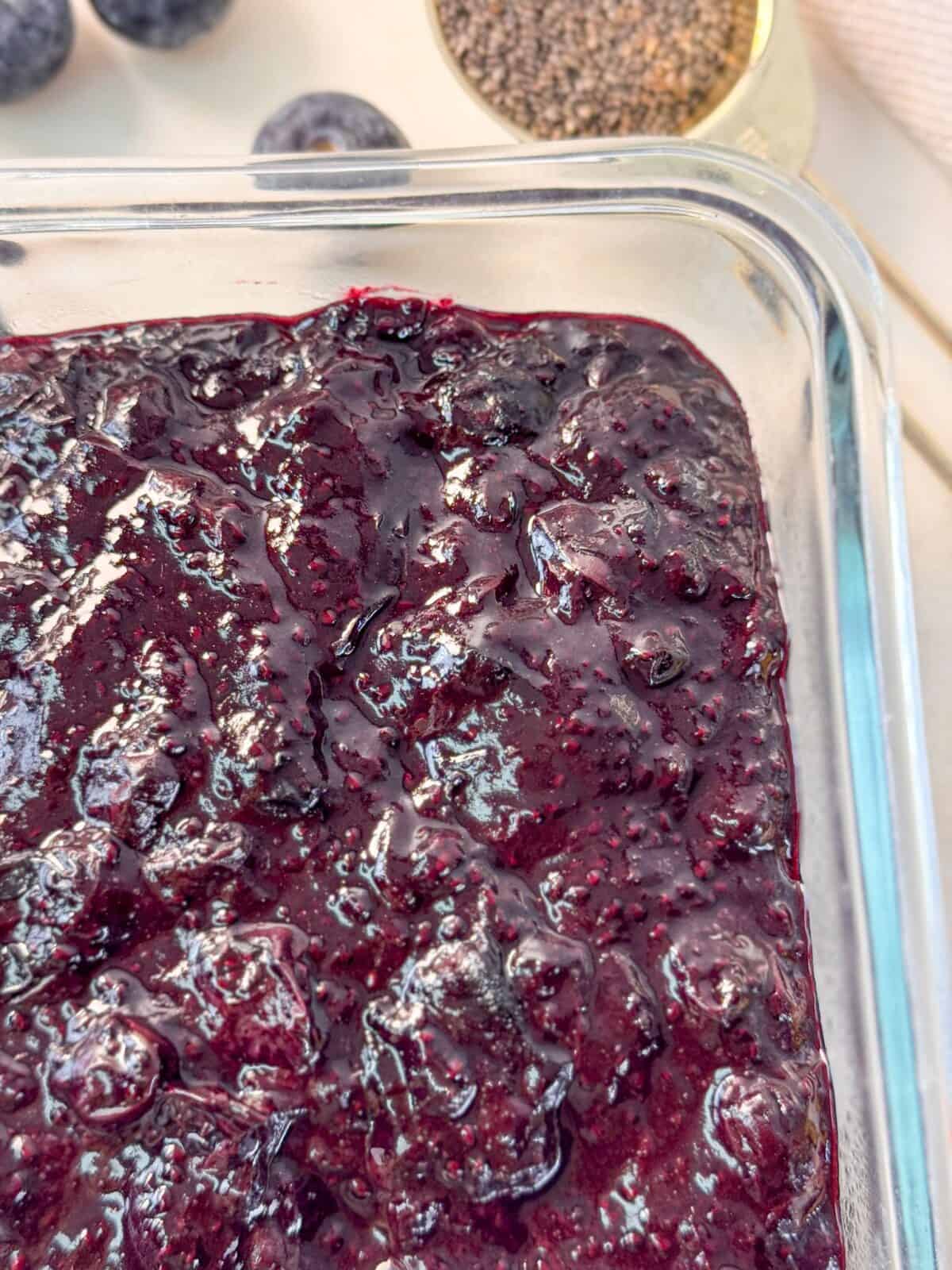 Homemade Blueberry Chia Seed Jam A close up shot of a glass container filled with homemade blueberry chia seed jam.
