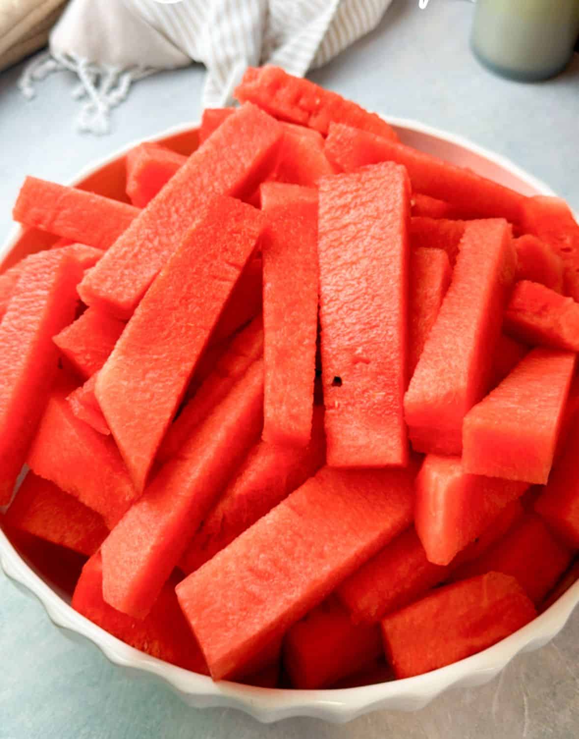 How to Cut Watermelon into Perfect Sticks juicy, refreshing watermelon sticks served in a large bowl