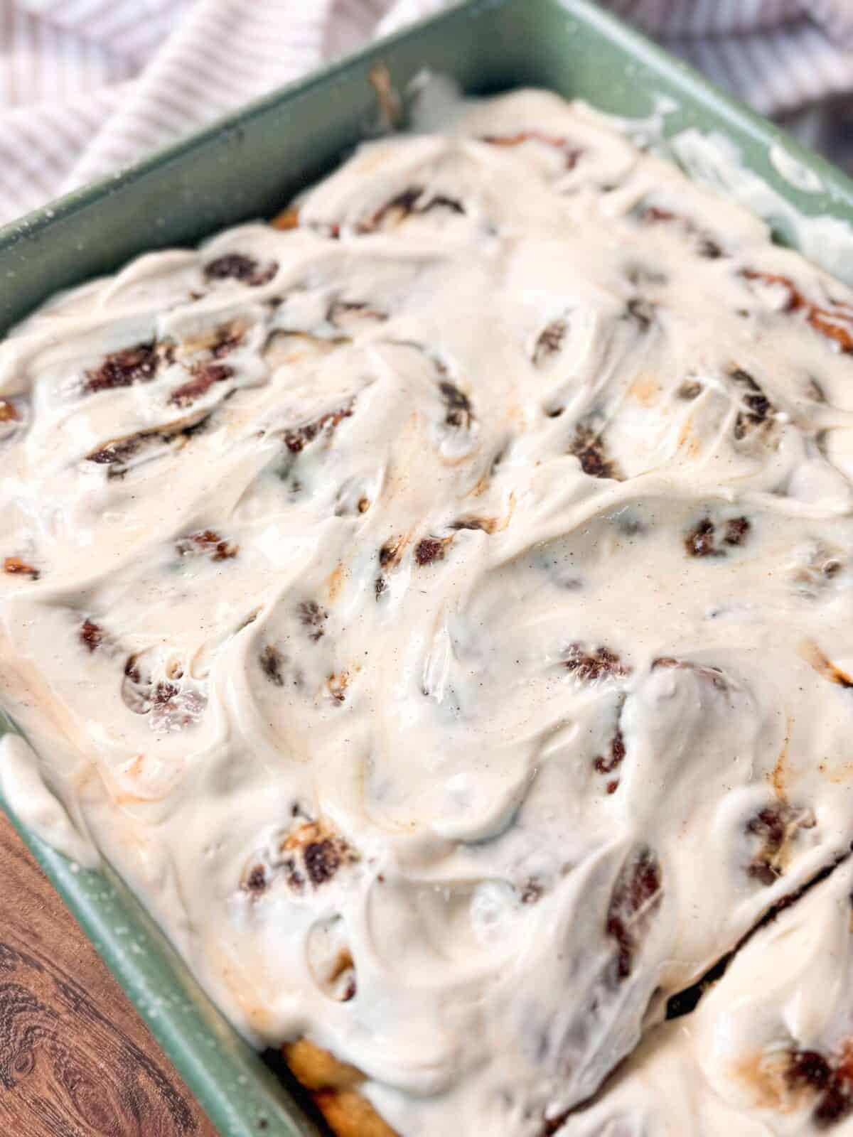 Soft Cinnamon Roll Focaccia a pan of warm baked soft cinnamon roll focaccia drizzled with icing and spread evenly