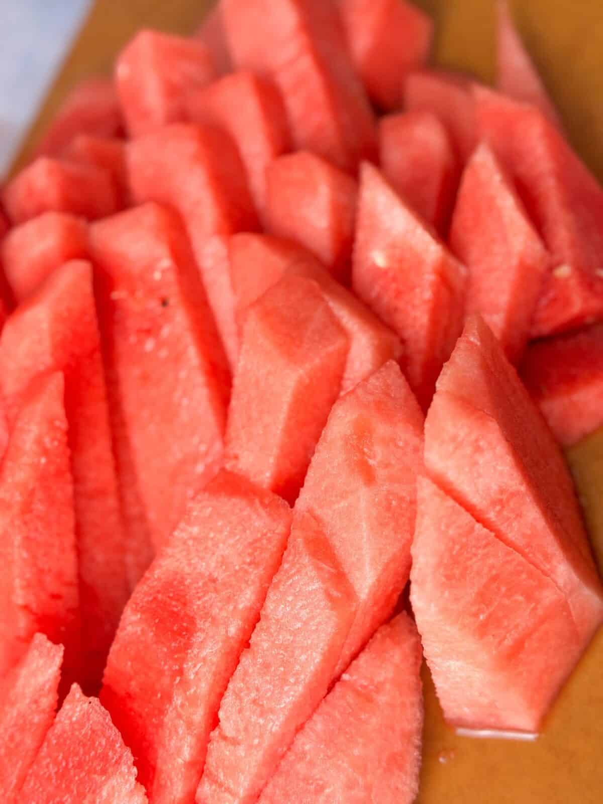 Juicy Watermelon Sticks juicy, refreshing watermelon sticks on a cutting board