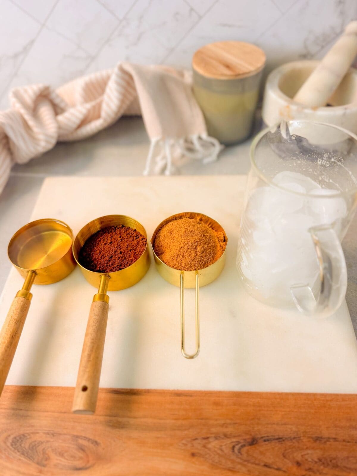 Whipped Coffee Mousse Ingredients whipped coffee mousse ingredients: ice, instant coffee, coconut sugar, cold water, and cacao powder, all placed in measuring cups