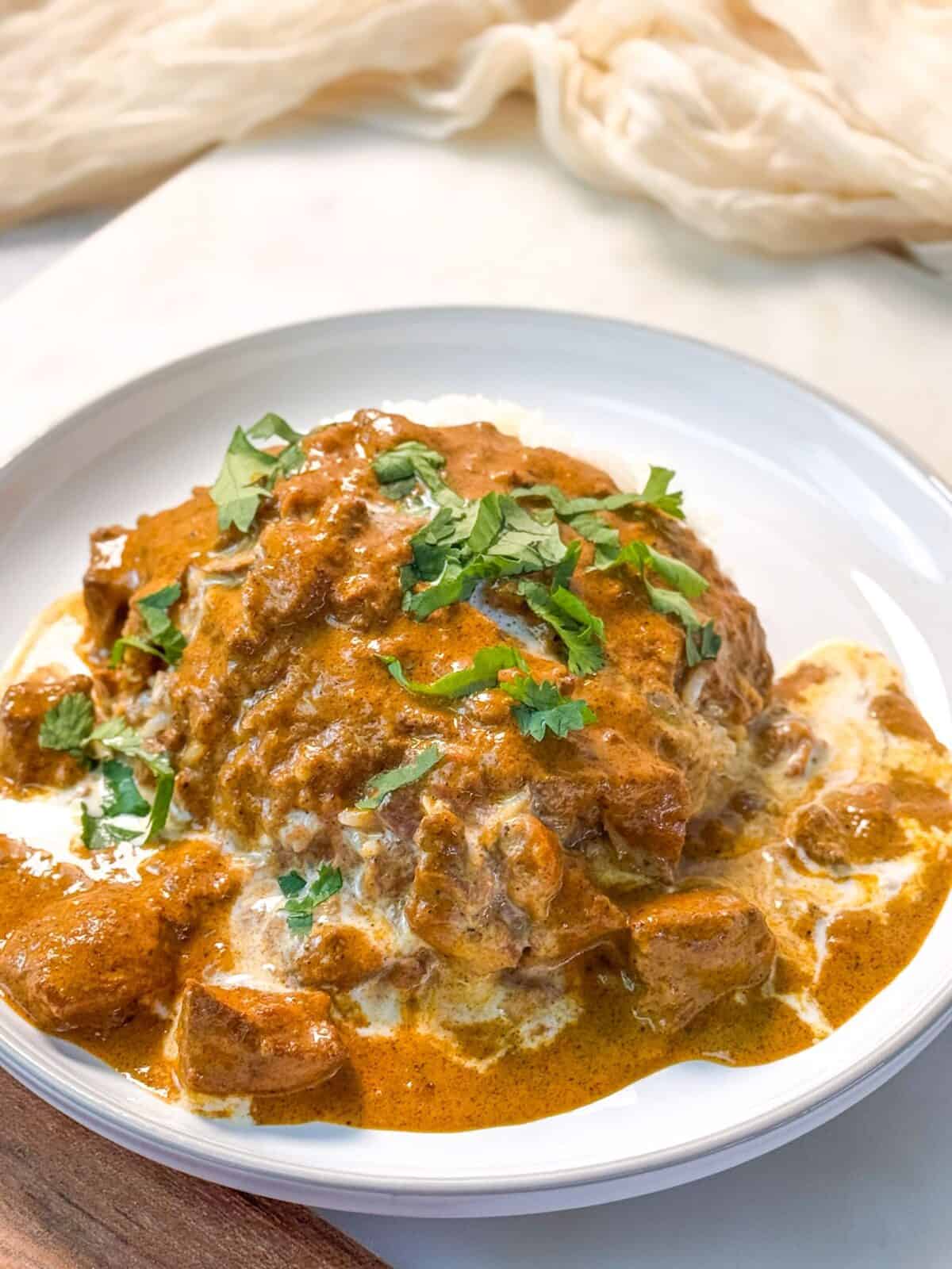 Butter Chicken Homemade butter chicken served over basmati rice and garnished with fresh cilantro