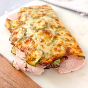 Gluten-free cheesy zucchini bread wrap filled with turkey and greens.