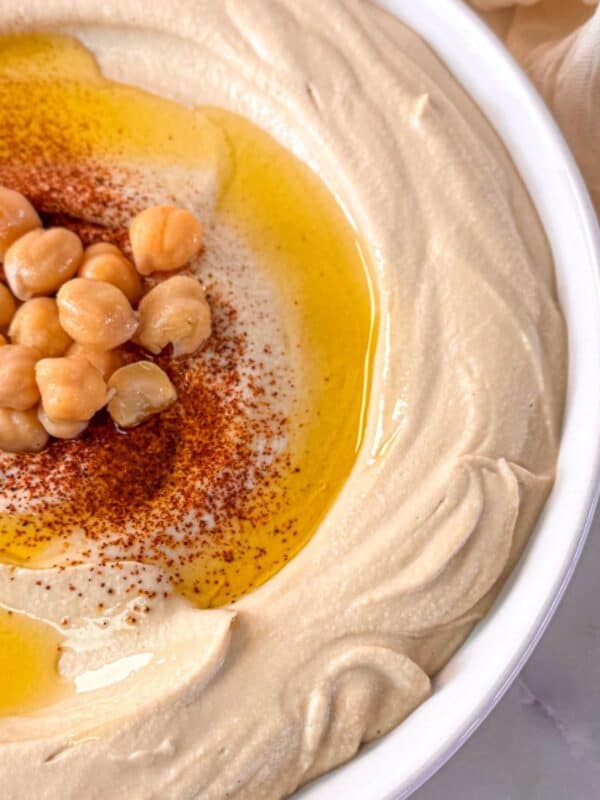creamy whipped hummus made with canned chickpeas, beautifully served in a white bowl.