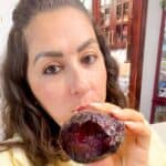 Lama is holding a roasted beet with one bite out