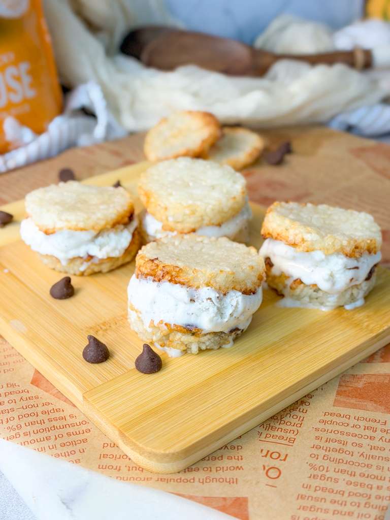 Air Fryer Crispy Rice Ice Cream Sandwich Air fryer crispy rice ice cream sandwiches with creamy vanilla filling served on a wooden board with chocolate chips.