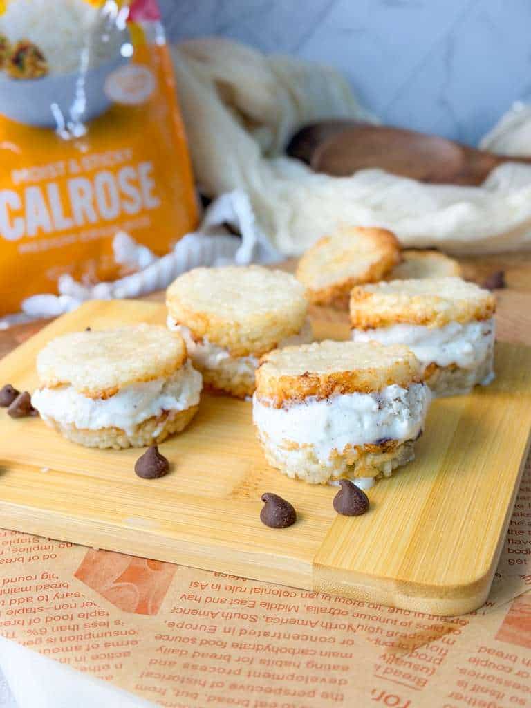 Crispy Rice Ice Cream Sandwich Air fryer crispy rice ice cream sandwiches with creamy vanilla filling served on a wooden board with chocolate chips.