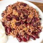 Traditional Lubya Hamra with red kidney beans, rice, and caramelized onions served with yogurt
