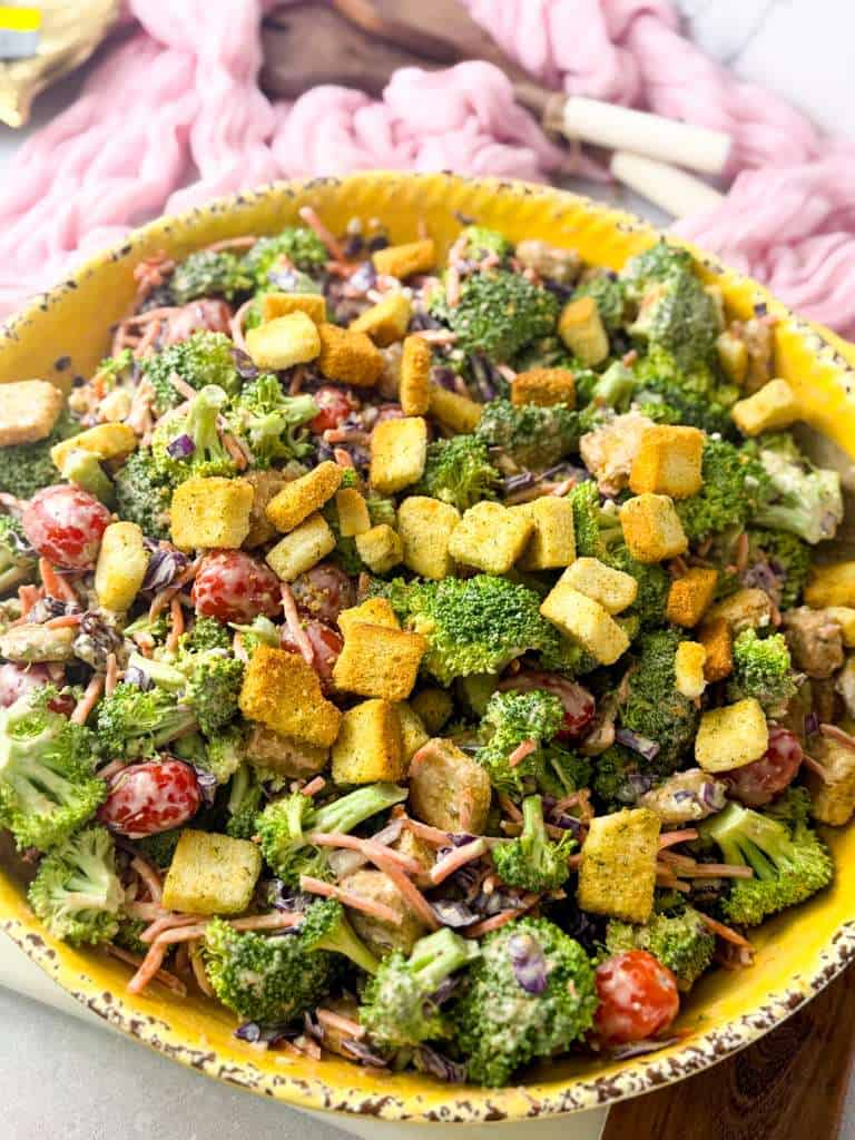 Broccoli and Blue Cheese Salad Broccoli crunch salad topped with seasoned croutons, cherry tomatoes, shredded carrots, purple cabbage, and creamy balsamic blue cheese dressing.